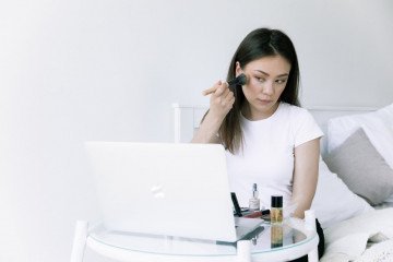 photo of woman looking on laptop