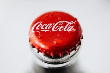 metal bottle cap with drops on white background